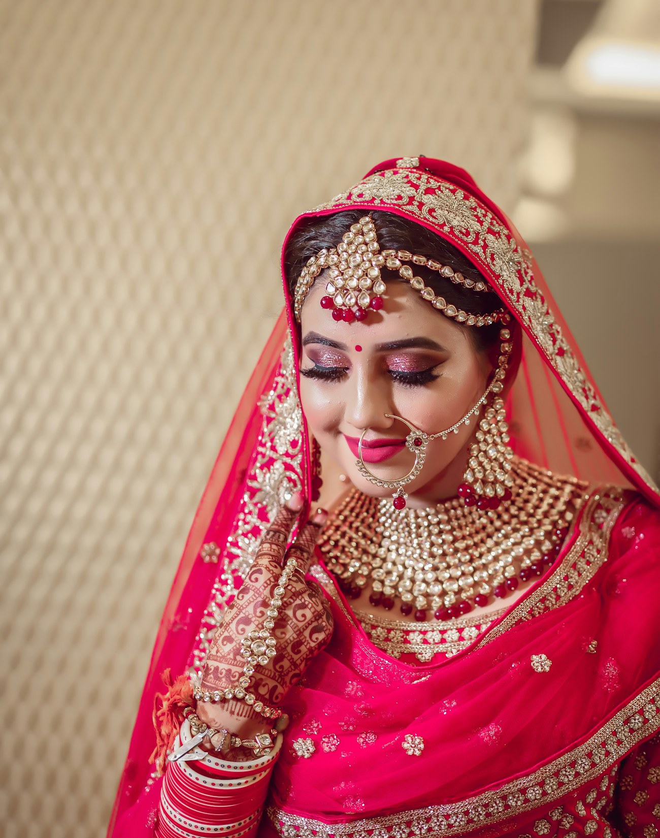Bride in red lehenga with gold jewellery