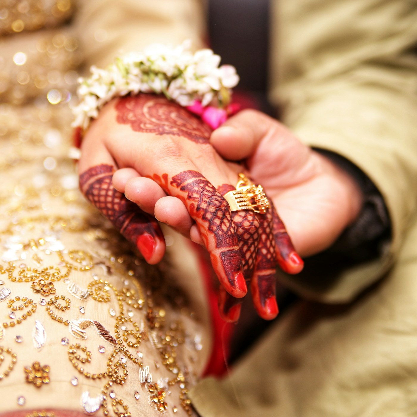 Mehndi hands with gold ring
